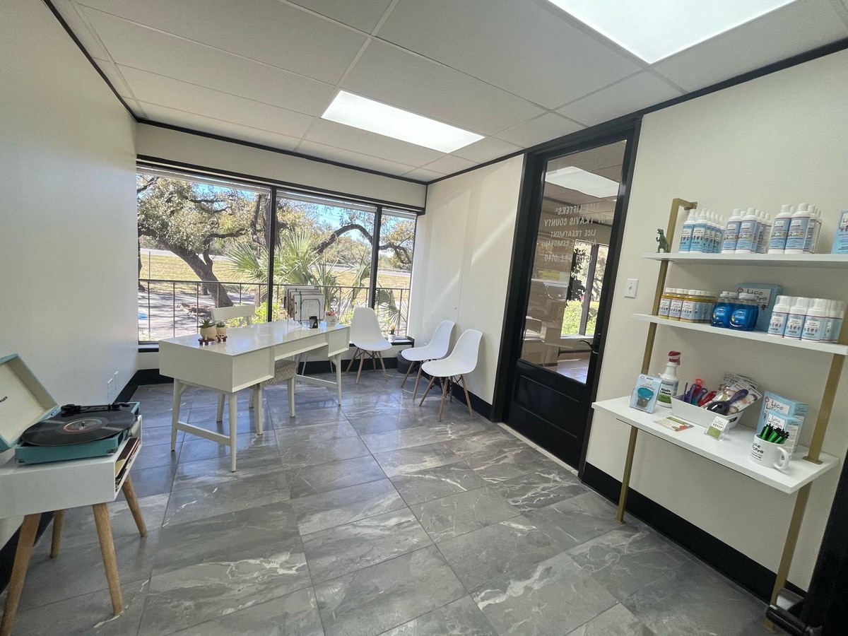 Bright Lakeway clinic room with a white desk, seating and a product shelf