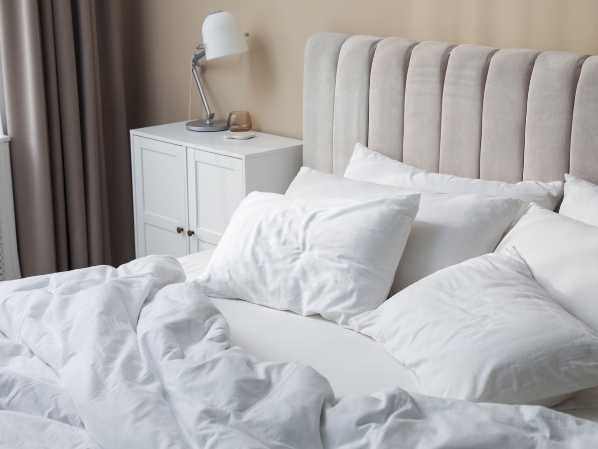 White pillows and fresh linens on a made bed